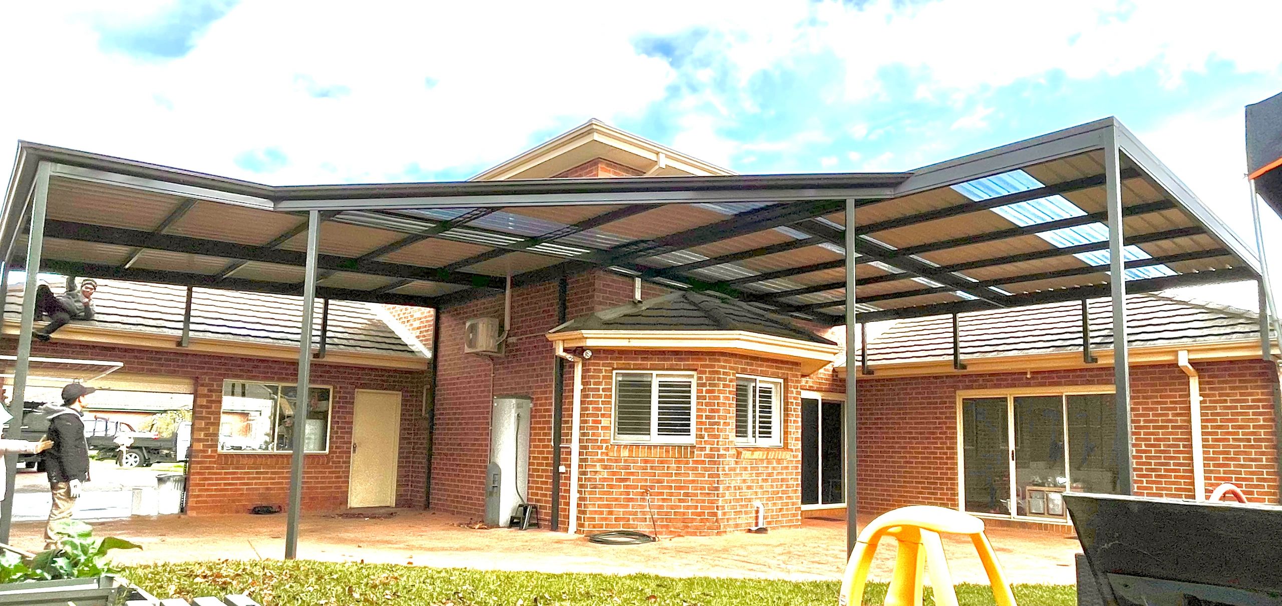 Metal pergola carport extending across front
